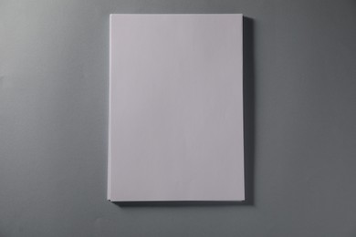 Photo of Stack of blank paper sheets on grey background, top view. Space for text