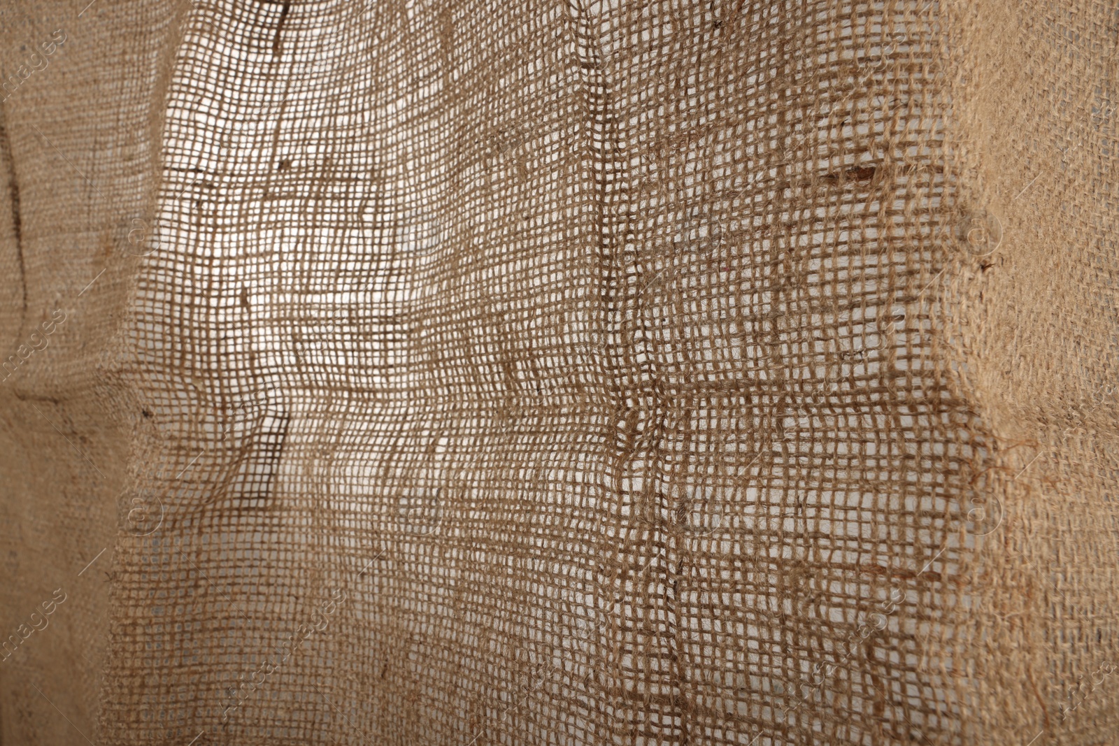 Photo of Texture of natural burlap fabric as background, closeup