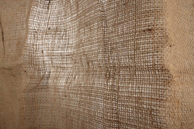 Photo of Texture of natural burlap fabric as background, closeup