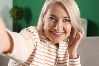 Photo of Mature woman using video chat at home, view from web camera