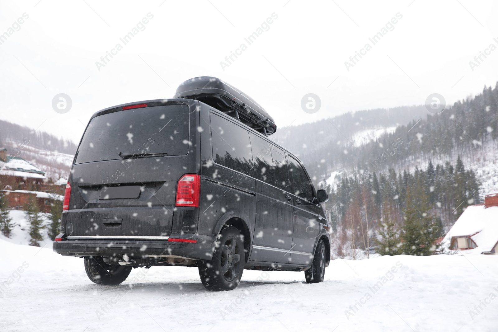 Photo of Black car on snowy road. Winter vacation