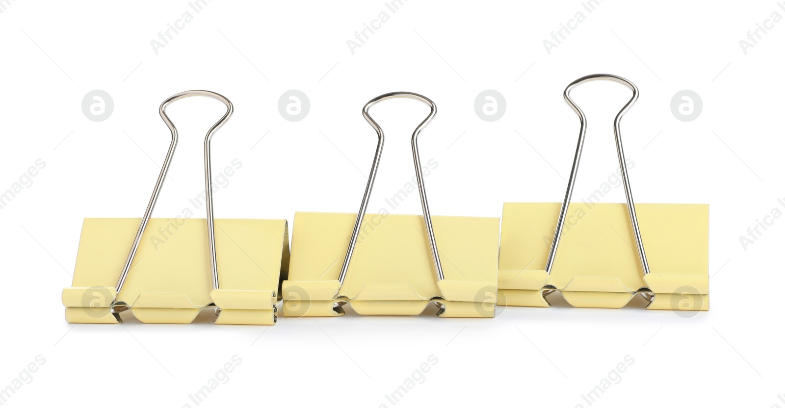 Photo of Yellow binder clips on white background. Stationery item