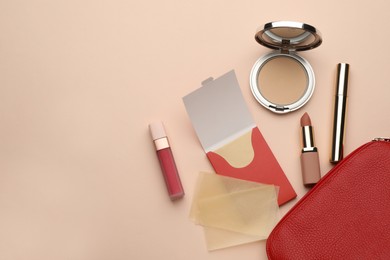 Photo of Flat lay composition with facial oil blotting tissues and makeup products on beige background, space for text. Mattifying wipes