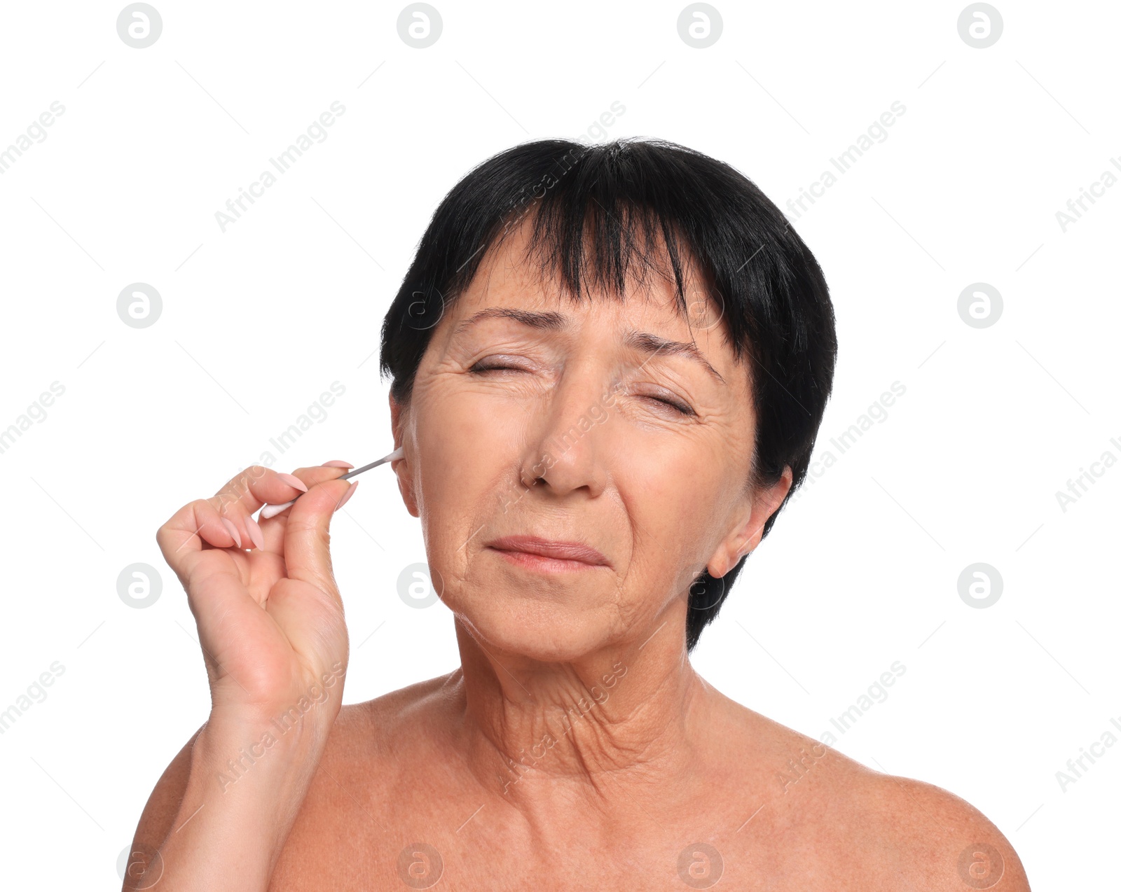 Photo of Senior woman cleaning ear with cotton swab on white background