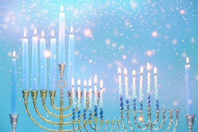 Hanukkah celebration. Menorahs with burning candles on light blue background