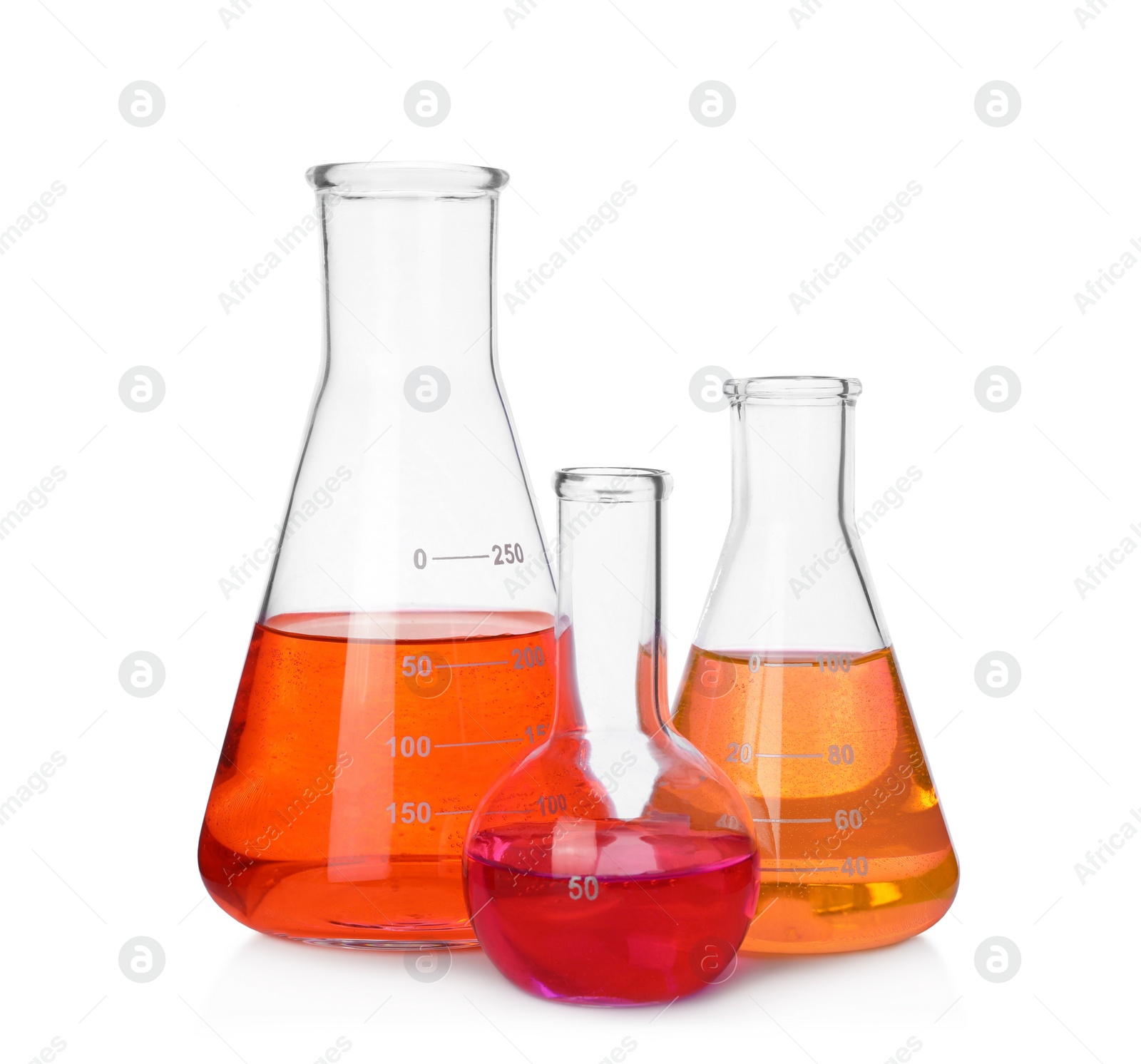 Photo of Different laboratory glassware with colorful liquids on white background