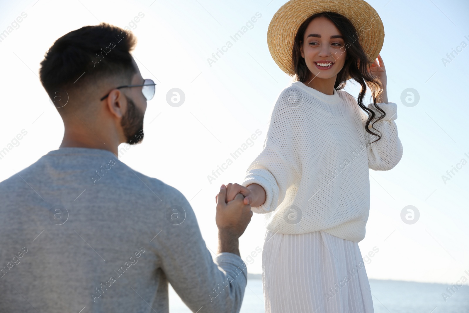 Photo of Happy young couple at beach. Honeymoon trip