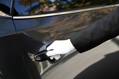 Photo of Driver opening car door, closeup. Chauffeur service