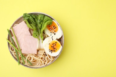 Photo of Delicious ramen with meat on pale yellow background, top view and space for text. Noodle soup
