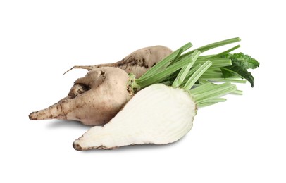 Photo of Whole and cut sugar beets on white background
