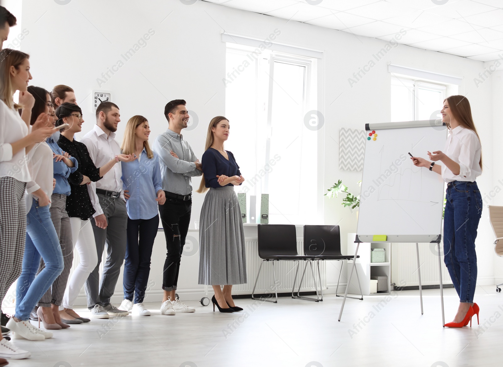 Photo of Female business trainer giving lecture in office