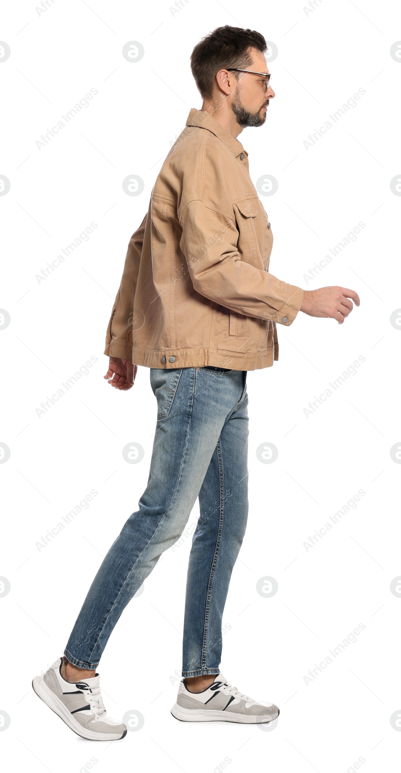 Photo of Man in stylish outfit walking on white background