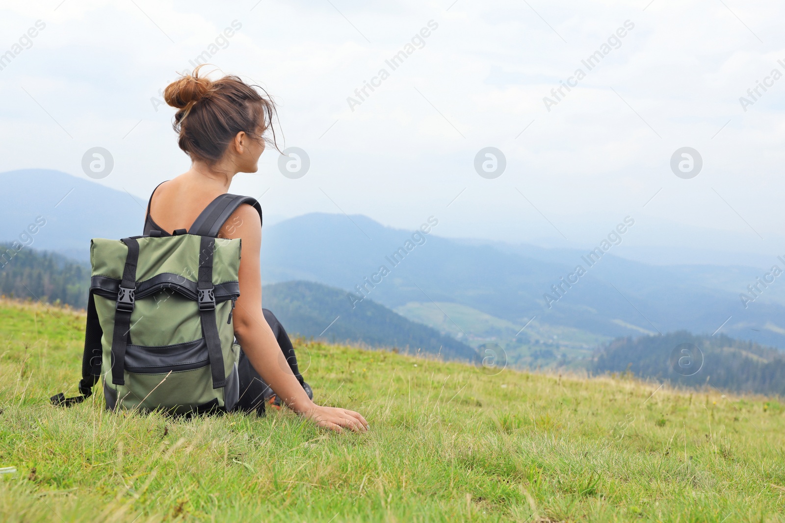 Photo of Woman with backpack in wilderness on cloudy day