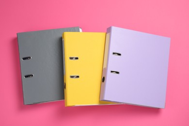 Photo of Office folders on pink background, flat lay