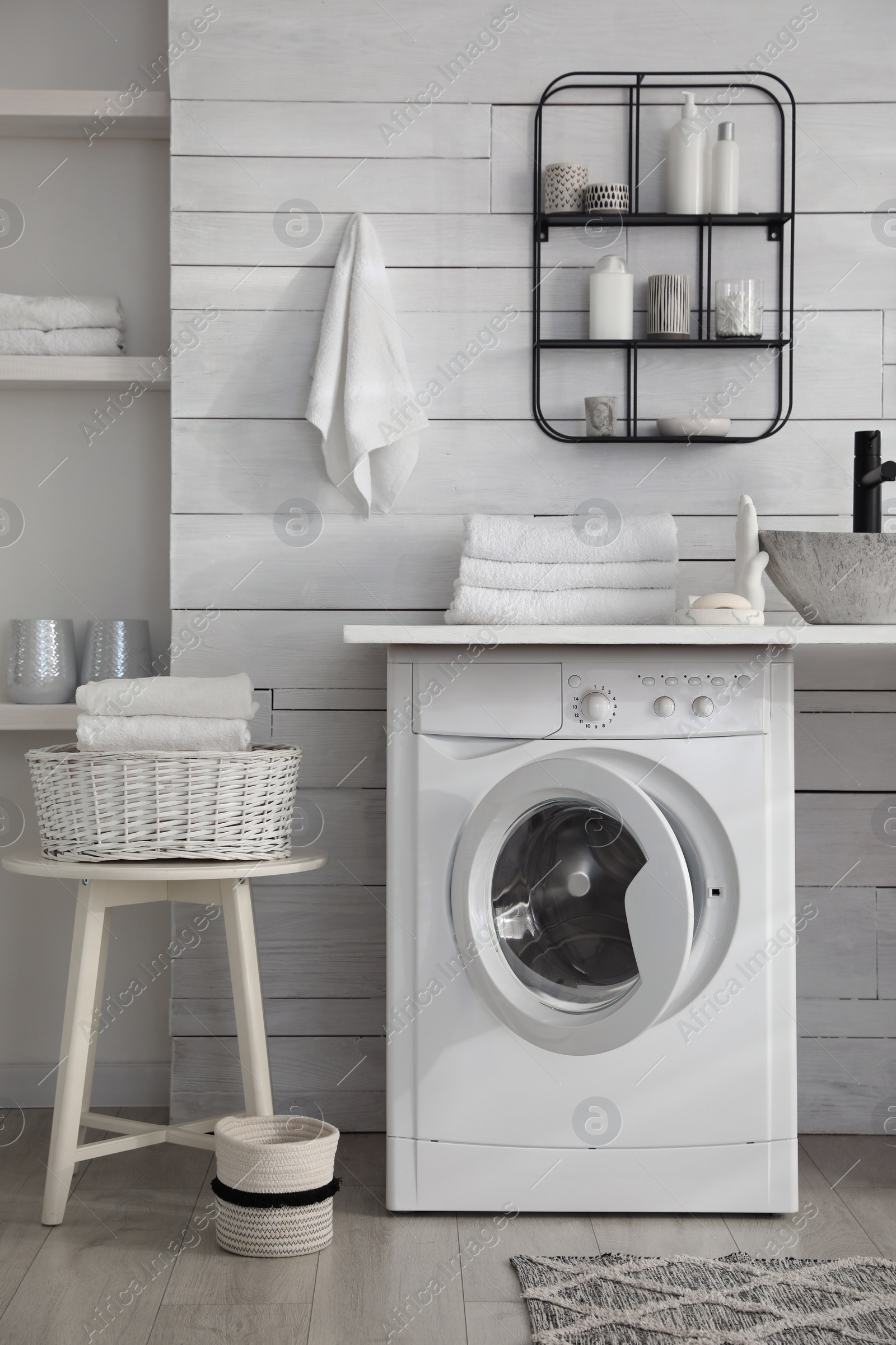 Photo of Stylish bathroom interior with modern washing machine