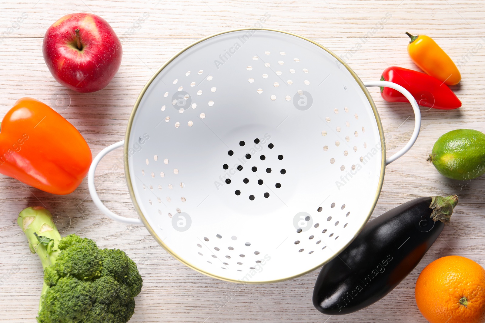 Photo of Empty colander, fresh fruits and vegetables on white wooden table, flat lay