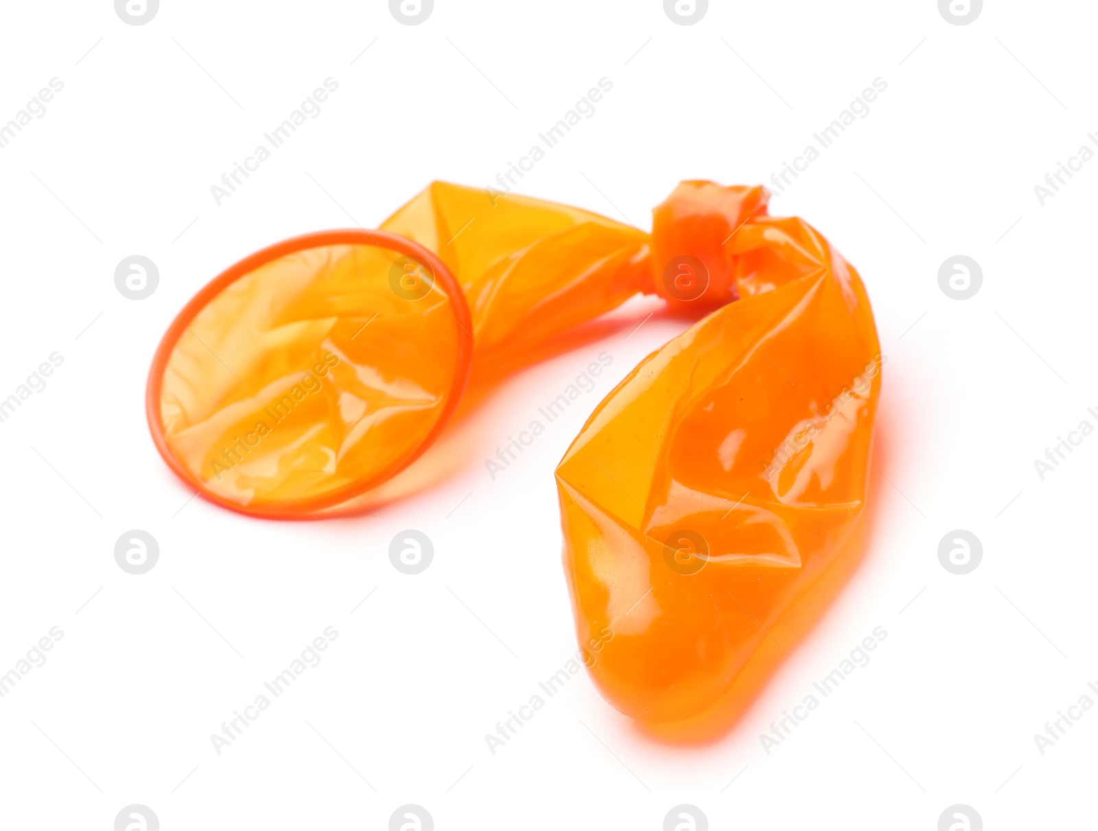 Photo of Orange used condom on white background. Safe sex concept