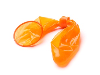 Photo of Orange used condom on white background. Safe sex concept