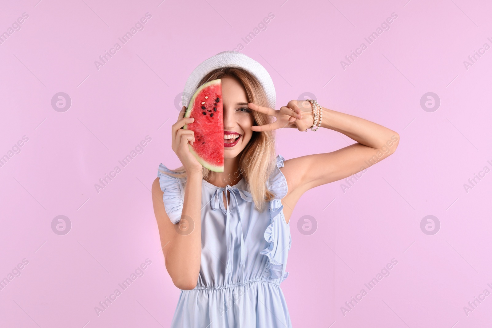 Photo of Pretty young woman with juicy watermelon on color background