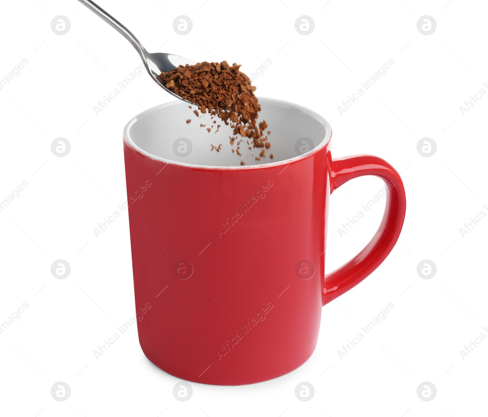 Photo of Pouring aromatic instant coffee into red cup on white background