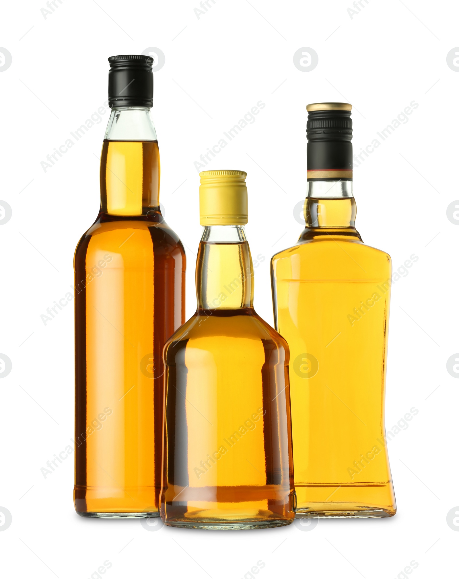 Photo of Different sorts of whiskey in glass bottles isolated on white