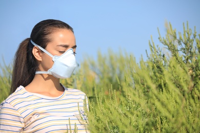 Young woman suffering from ragweed allergy outdoors