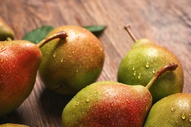 Tasty ripe pears on wooden table, closeup