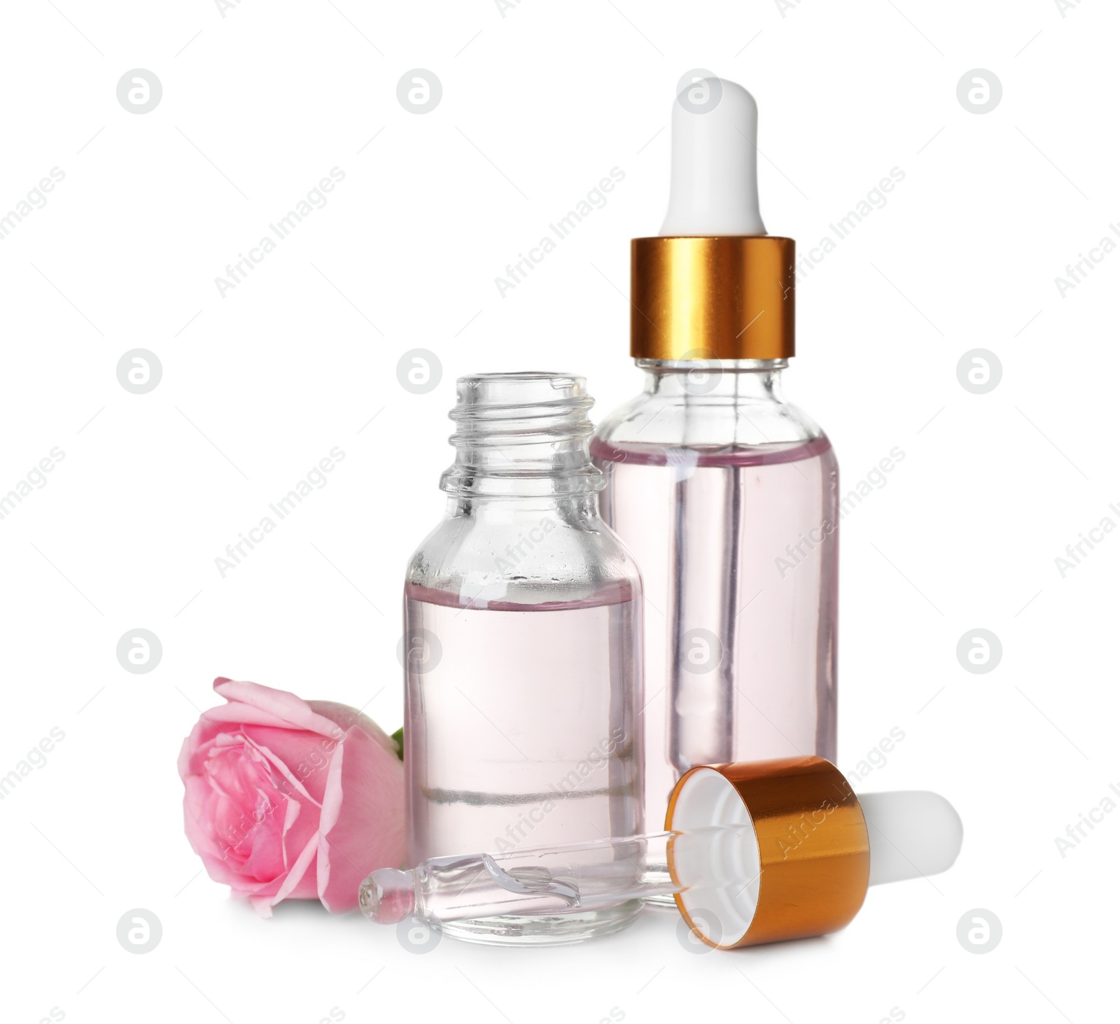 Photo of Bottles with rose essential oil and flower on white background