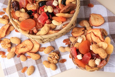 Photo of Mixed dried fruits and nuts on beige background, above view
