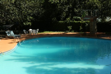 Photo of Pool with clean water and sunbeds outdoors