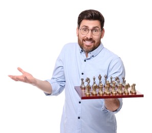 Confused man holding chessboard with game pieces on white background