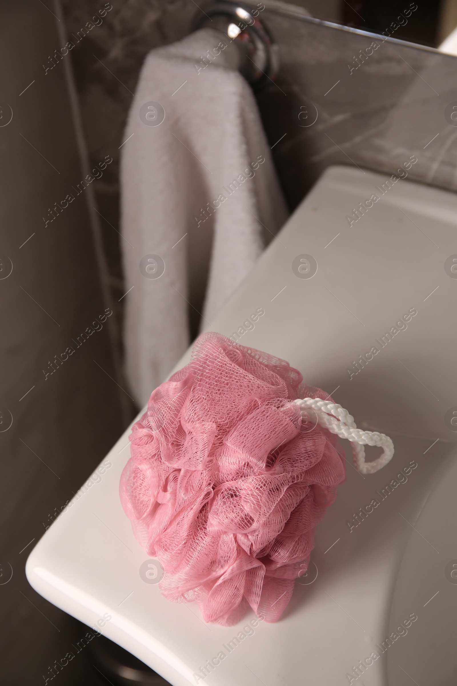Photo of Pink shower puff on washbasin in bathroom, above view