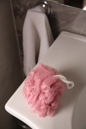 Pink shower puff on washbasin in bathroom, above view