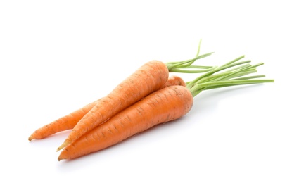 Ripe fresh carrots on white background