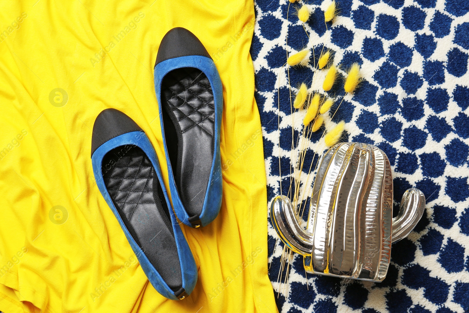 Photo of Pair of female shoes on fabric, top view