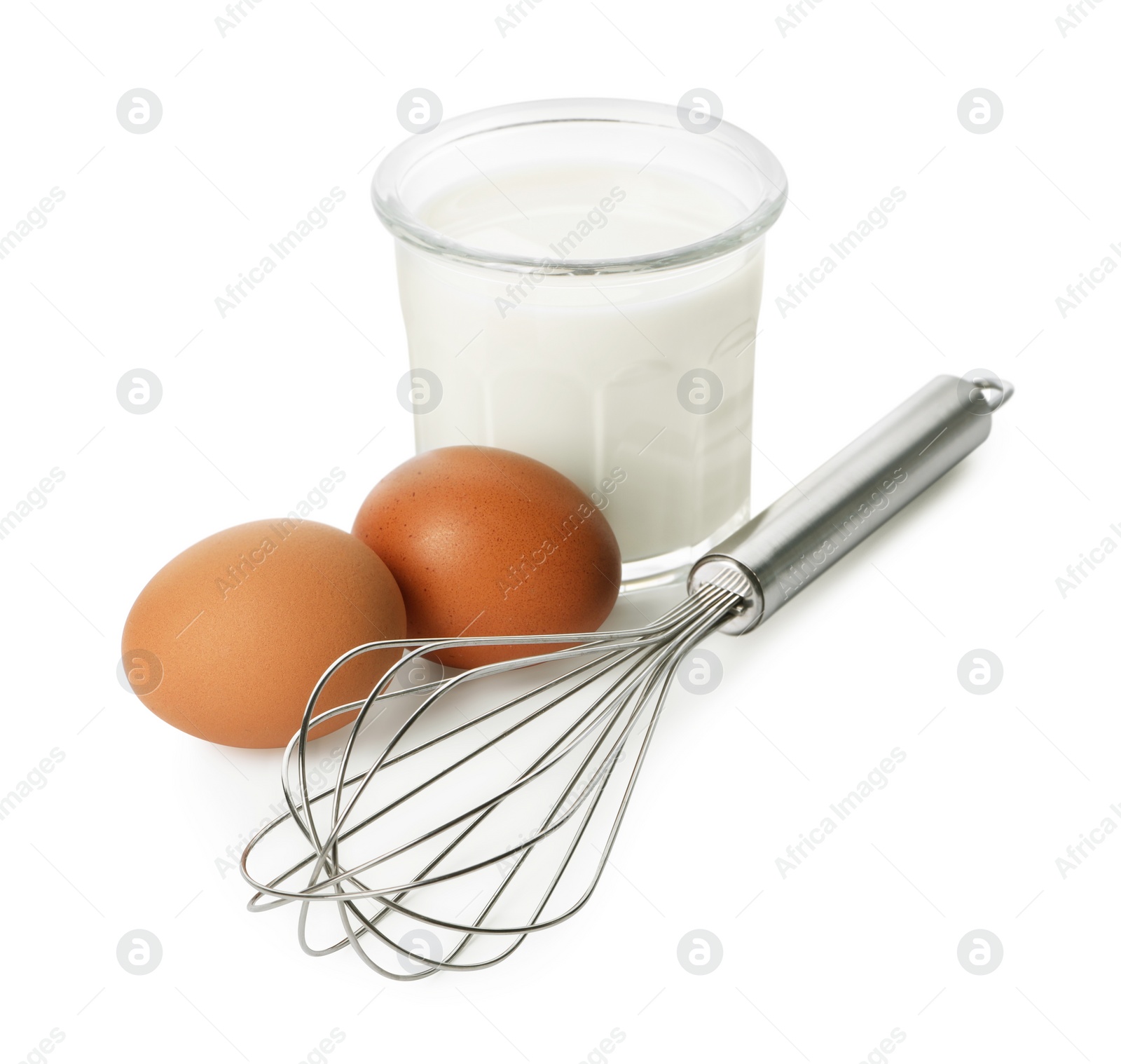 Photo of Metal whisk, raw eggs and glass of milk isolated on white