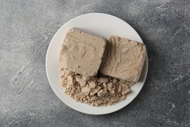 Compressed yeast on grey table, top view