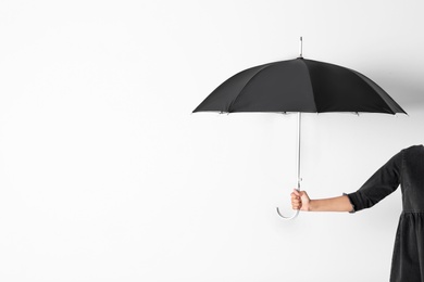 Photo of Person holding open umbrella on white background with space for design