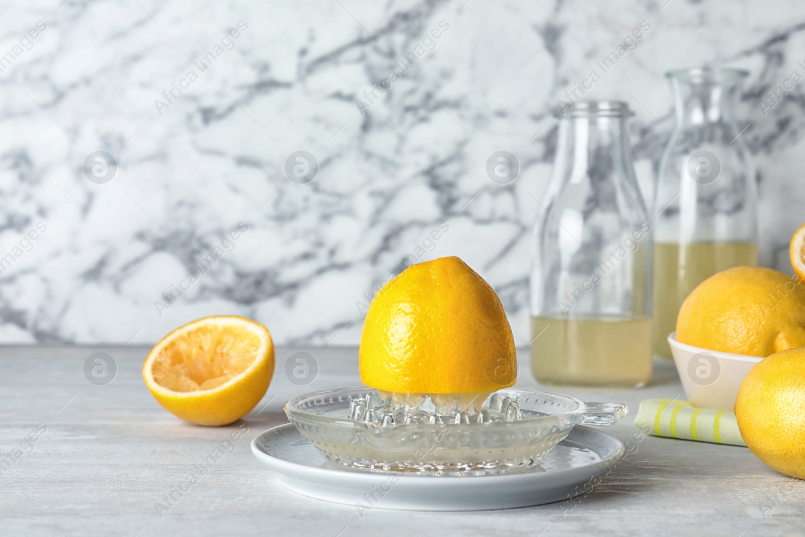 Photo of Composition with glass squeezer and lemon half on table