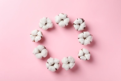 Photo of Flat lay composition with cotton flowers on pink background. Space for text