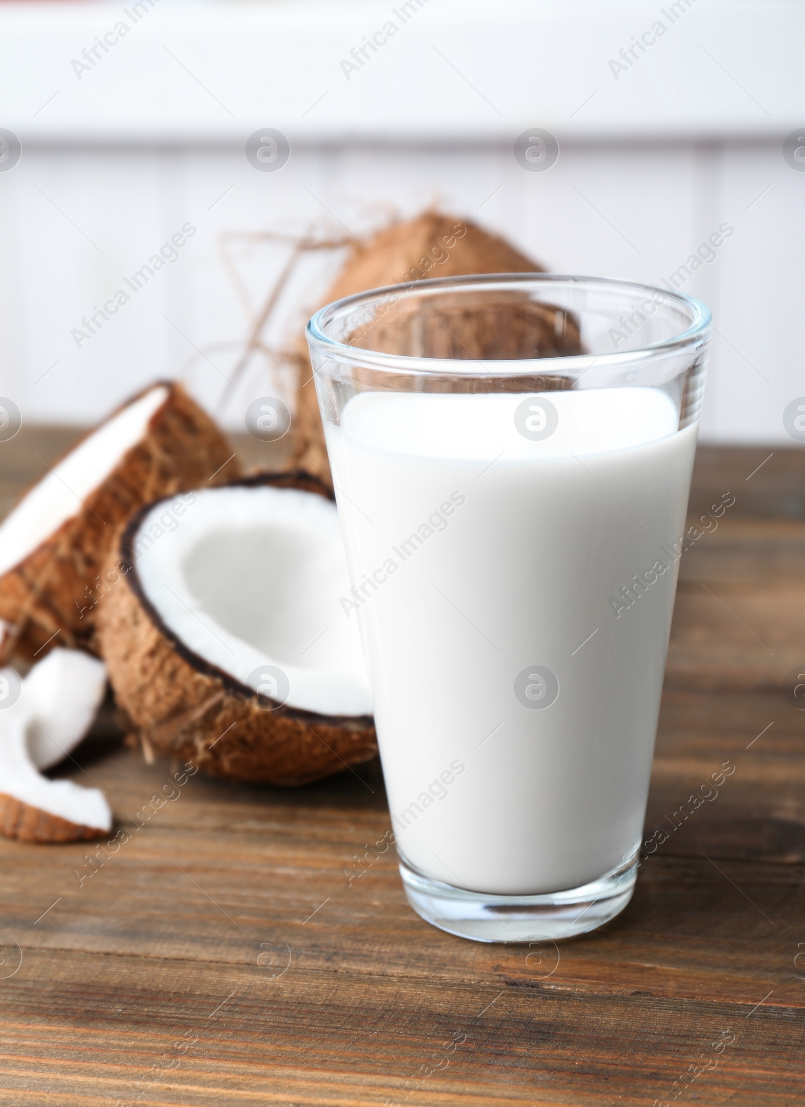 Photo of Glass of coconut milk on wooden table