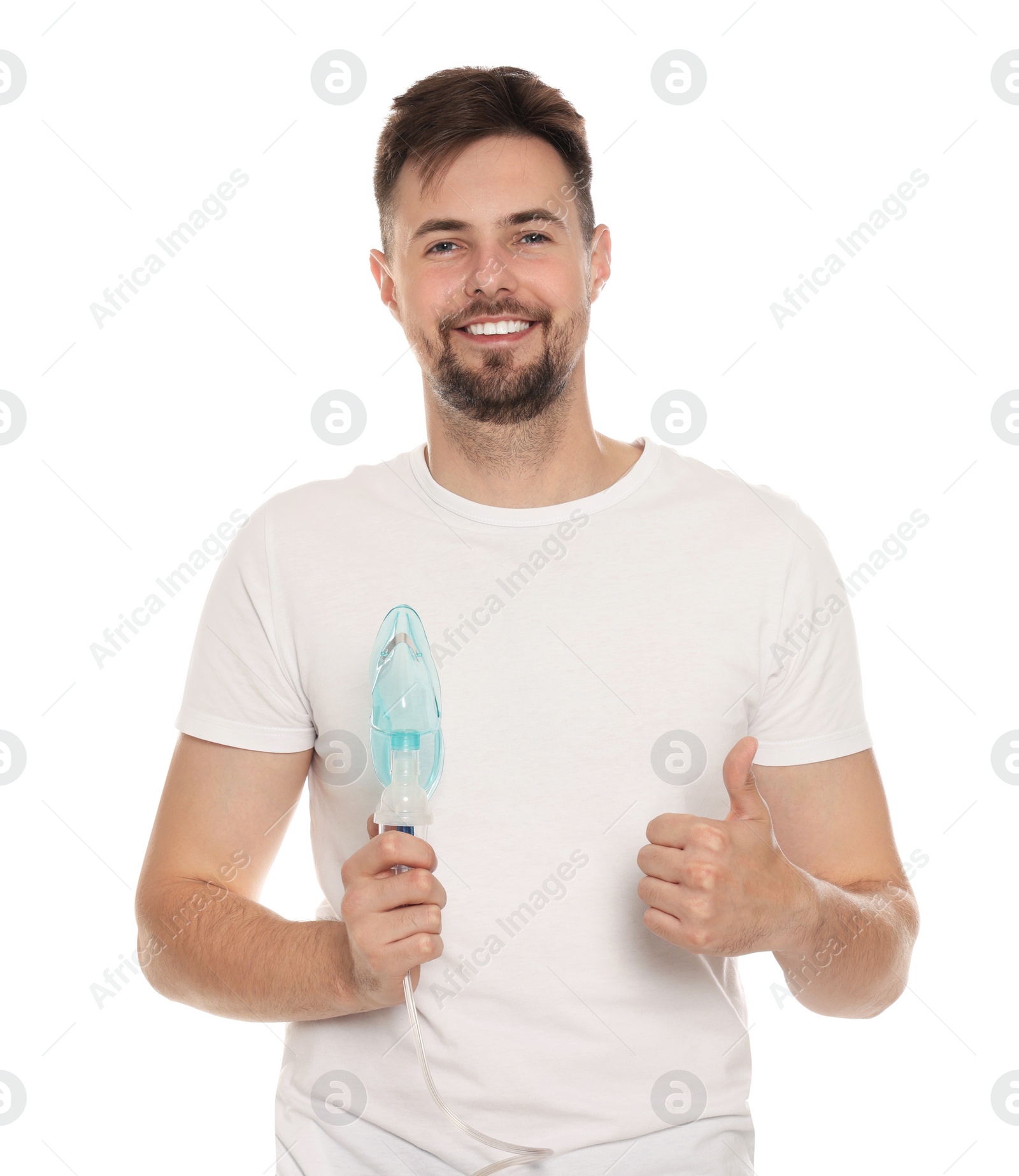 Photo of Man holding nebulizer for inhalation and showing thumb up on white background