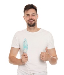 Photo of Man holding nebulizer for inhalation and showing thumb up on white background