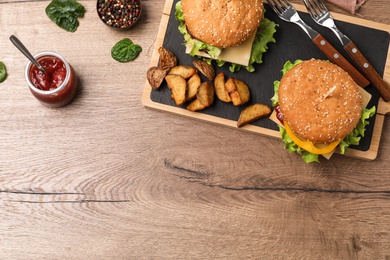 Photo of Flat lay composition with tasty hamburgers on wooden background. Space for text