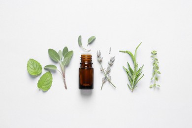 Bottle of essential oil, different herbs and lavender flowers on white background, flat lay