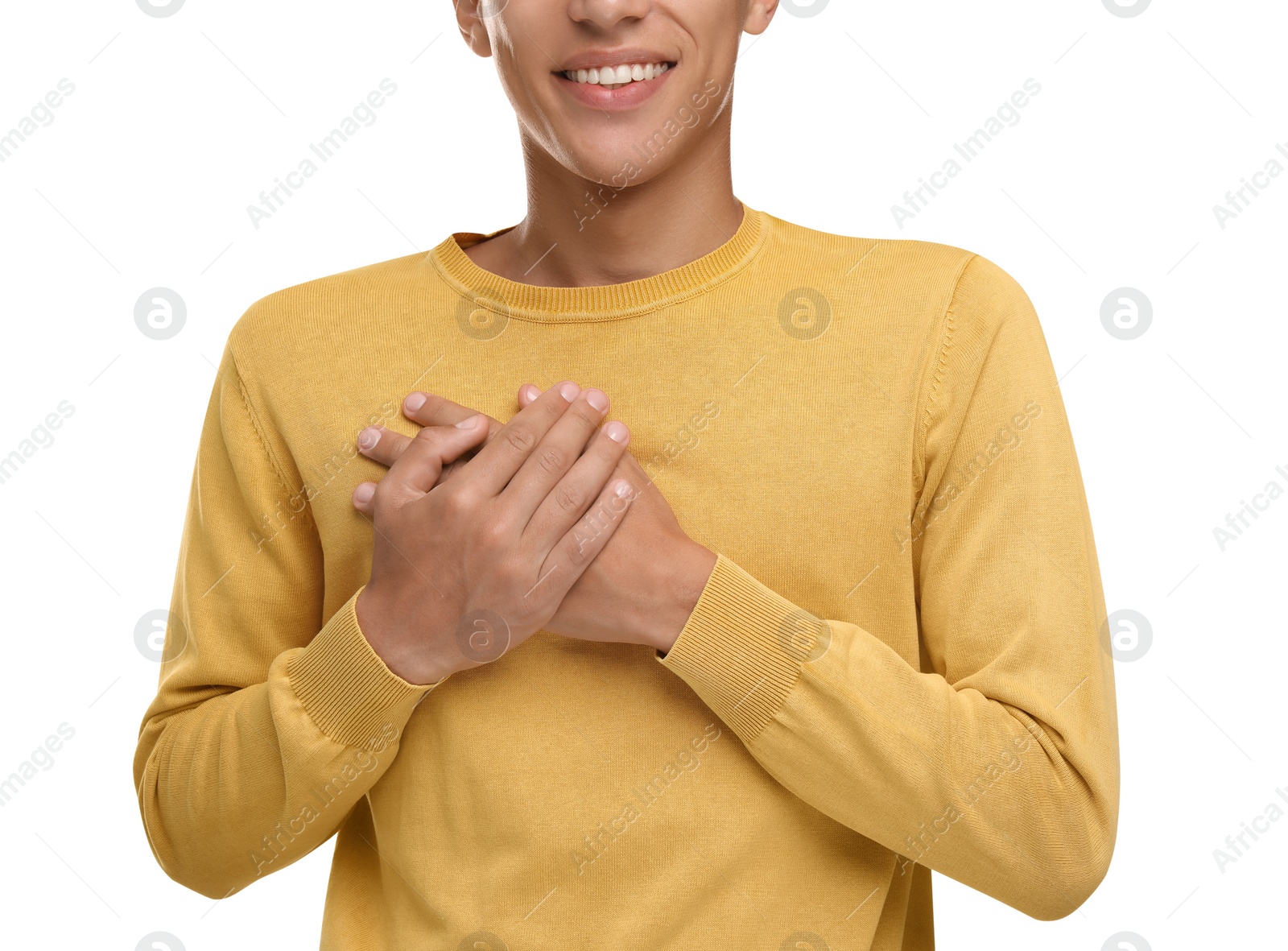 Photo of Thank you gesture. Grateful man with hands on chest against white background, closeup