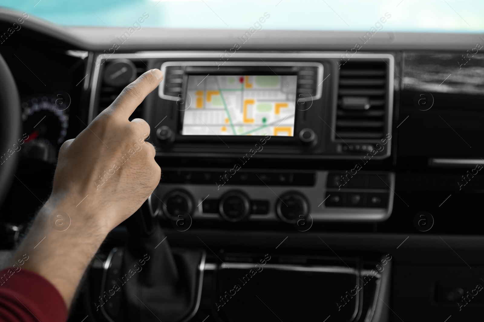 Image of Man using navigation system while driving car, closeup