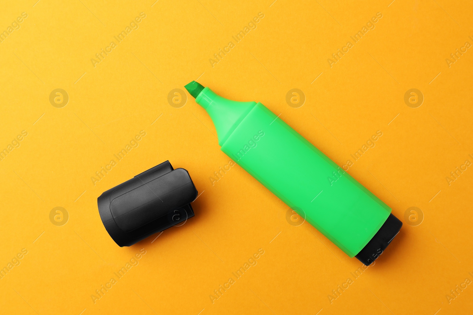 Photo of Bright marker on orange background, flat lay