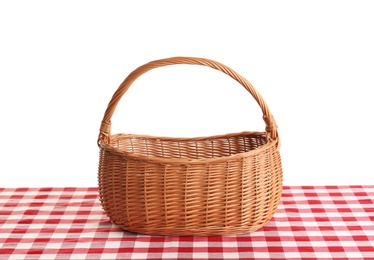 Photo of Empty picnic basket on checkered tablecloth against white background