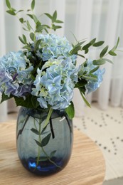 Beautiful blue hortensia flowers in vase on table indoors